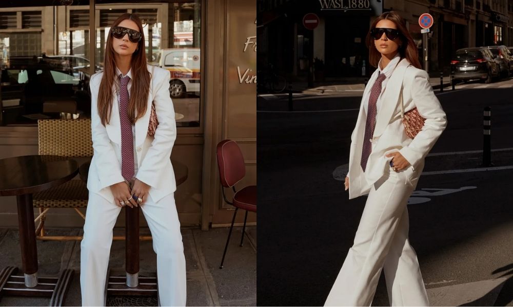 Mulher elegante celebrando o Mês da Mulher usando look sofisticado em ambiente urbano, destacando o empoderamento feminino e a independência.